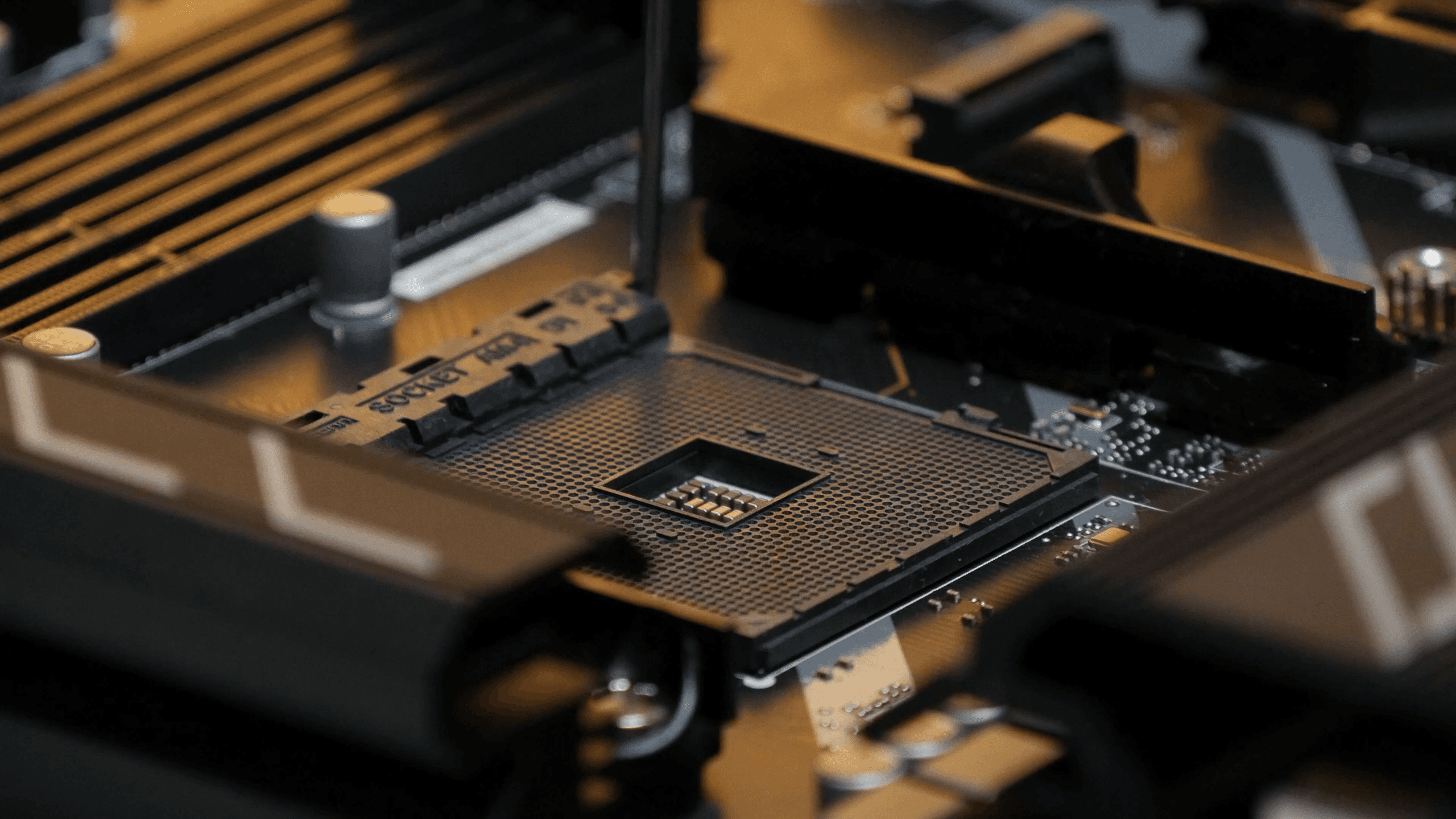 Close-up of a computer motherboard CPU socket and RAM slots