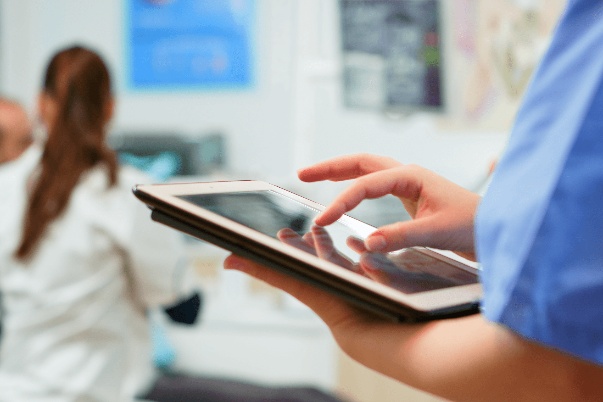 Healthcare professional using a tablet in a clinical setting, representing digital health innovation and healthcare software development trends in 2026.
