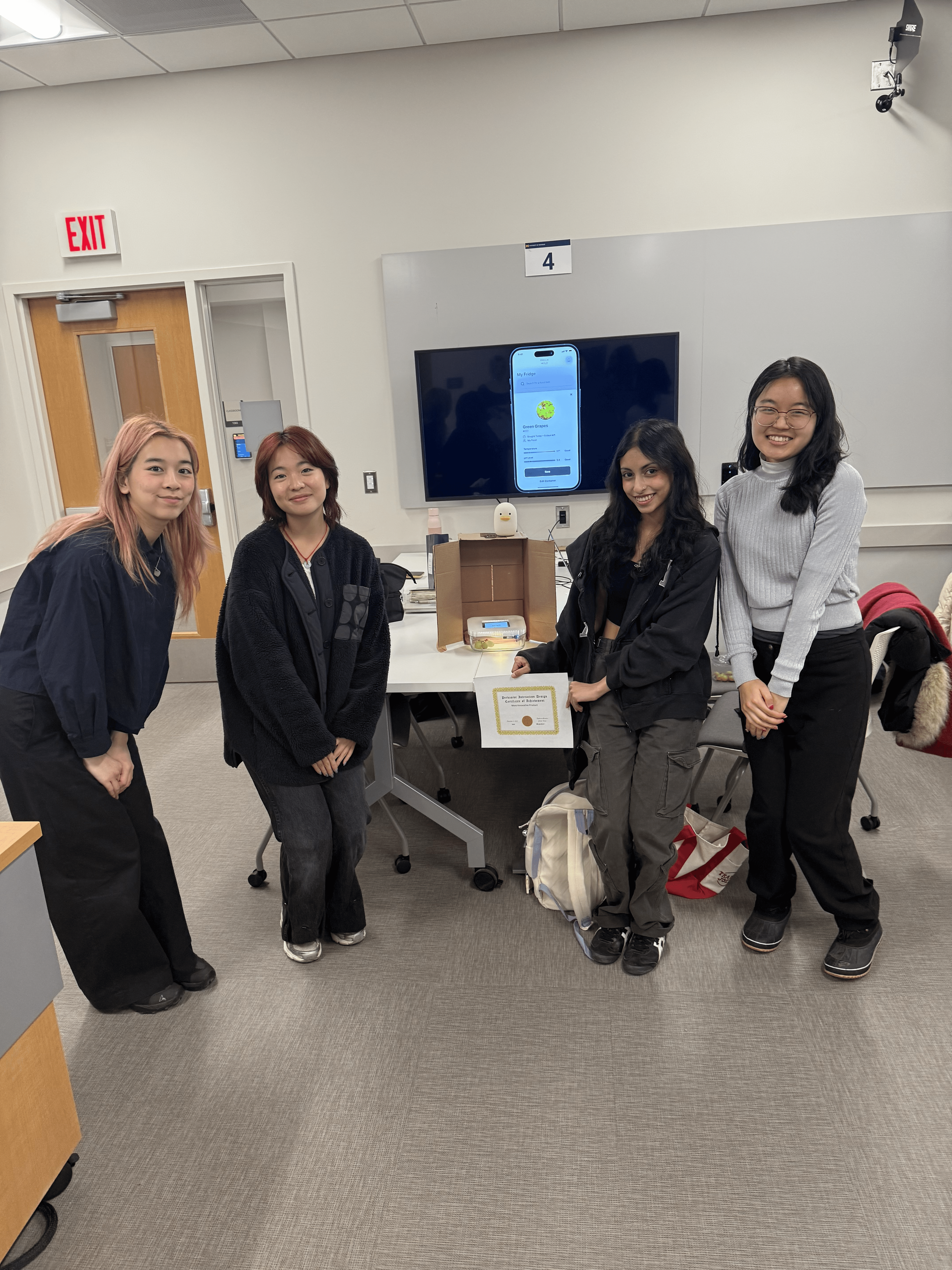 Four team members standing around the FreshHold product holding an award certificate