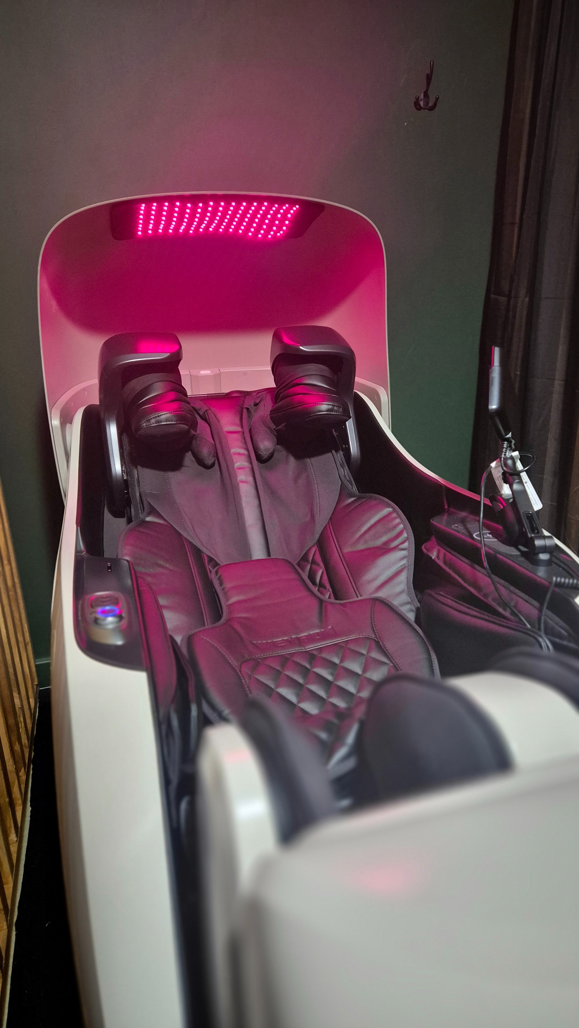Inside the Red Light Therapy Massage Pod with the red light panel glowing