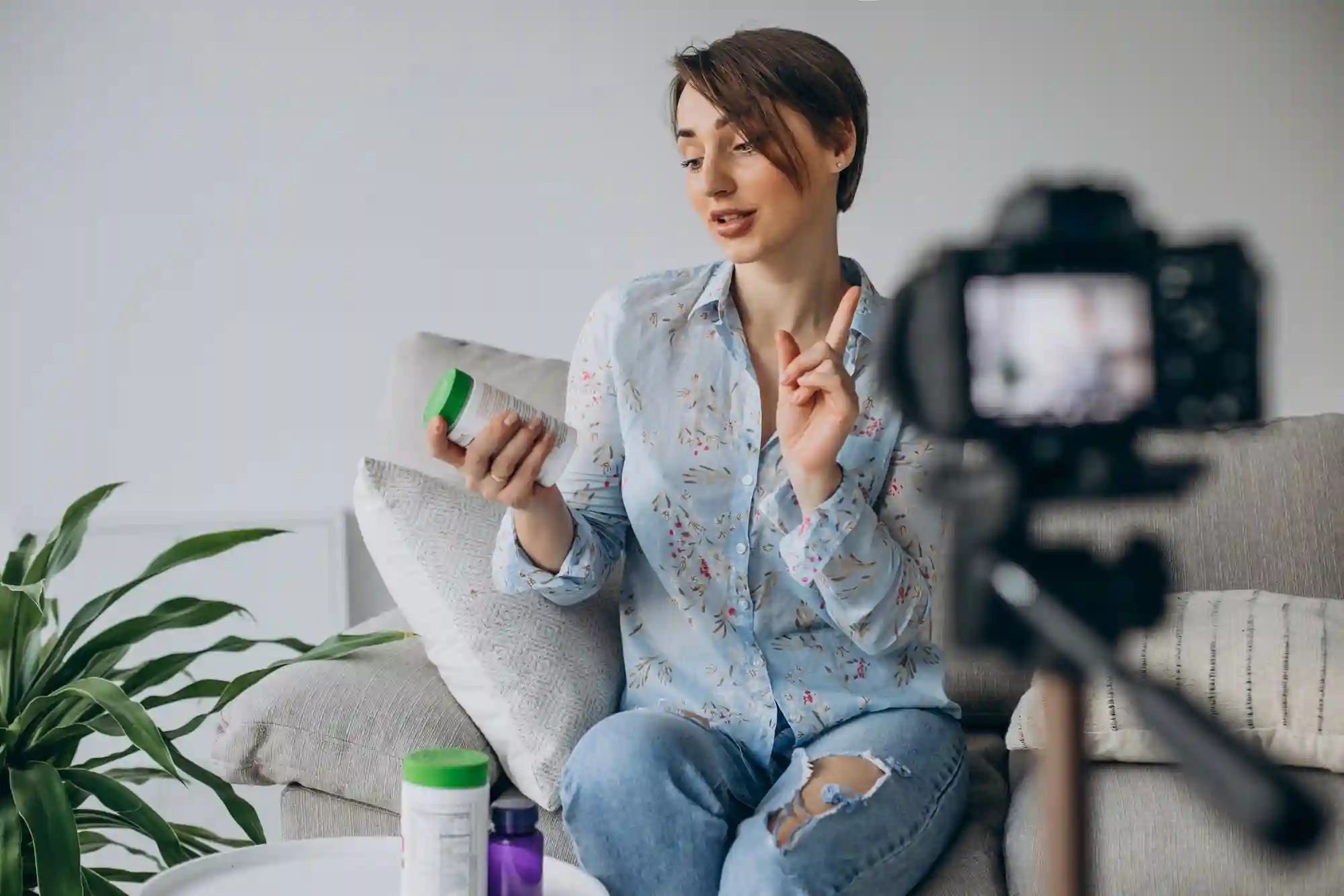 Woman recording a video review of wellness supplements or vitamins for her social media audience.
