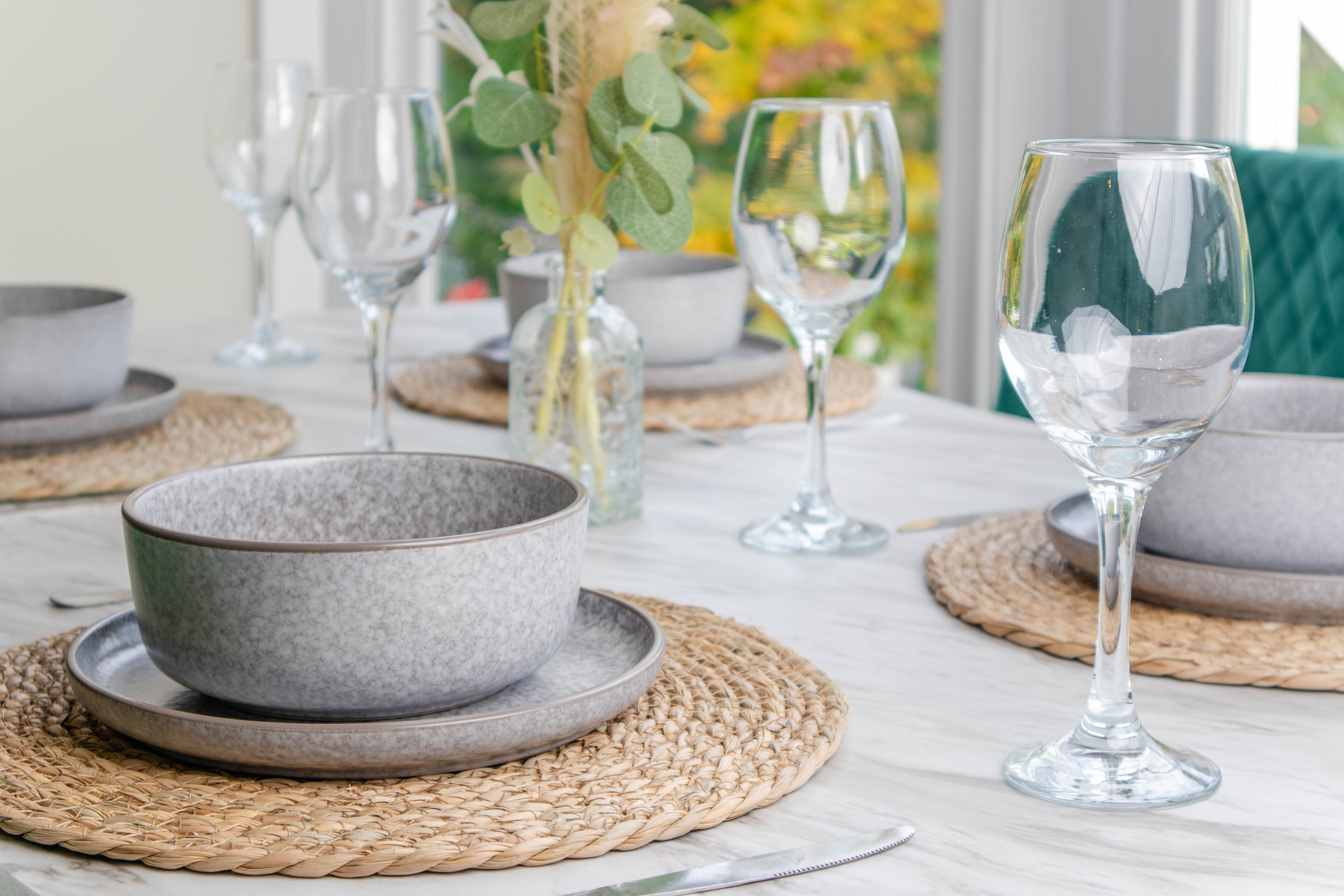 Mordern Airbnb photography of a dining table with wine glasses and grey ceramic bowl