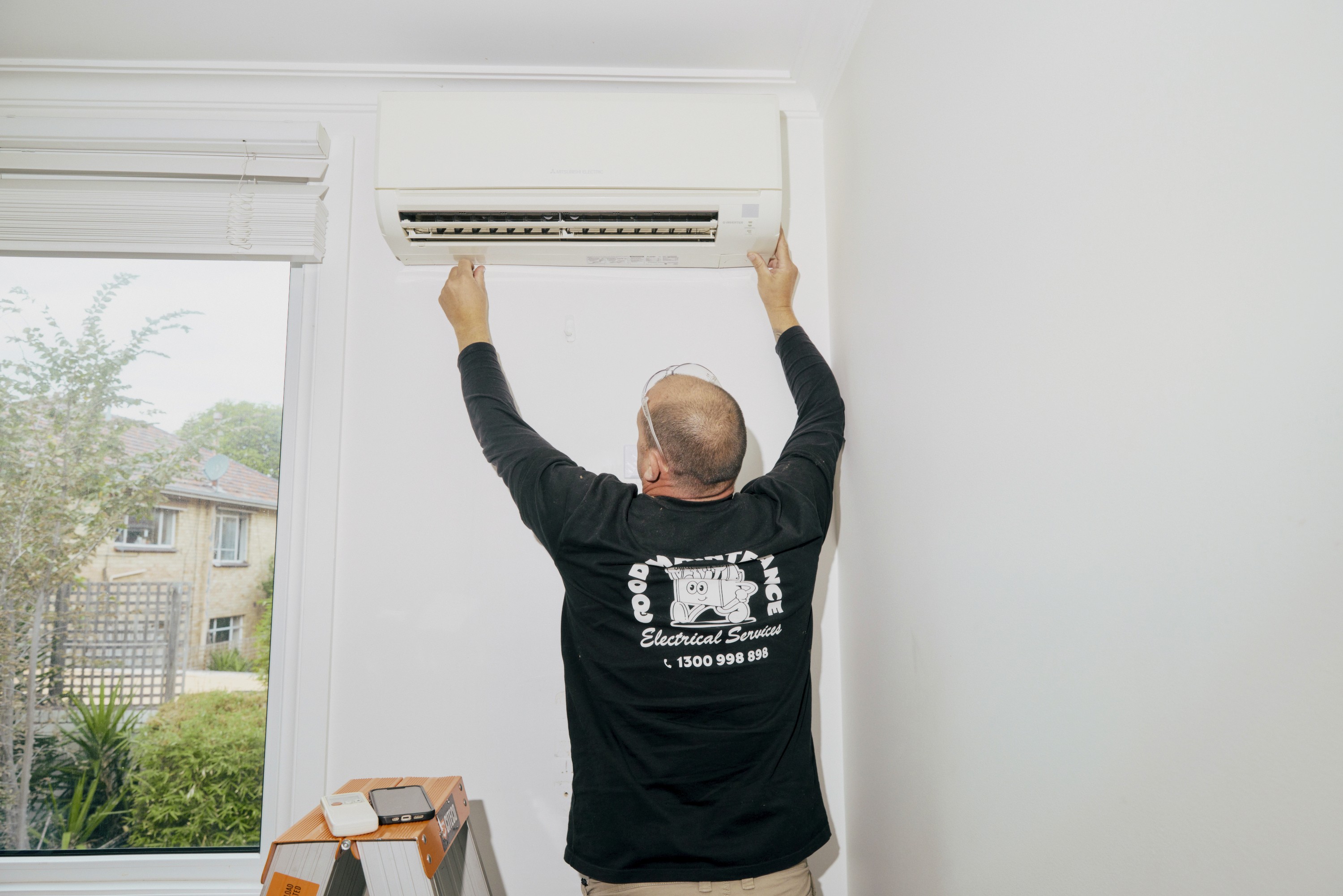 Good Maintenance technician unloading tools from service van for air conditioning repair in Melbourne.