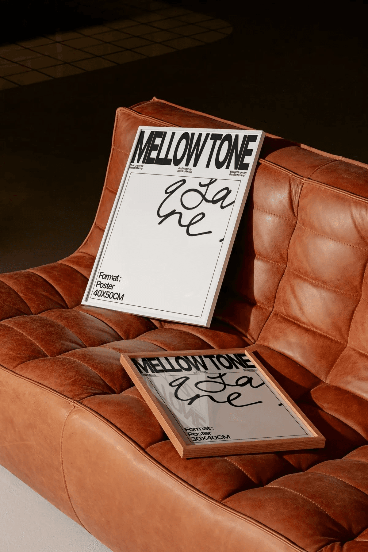 man wearing grey t-shirt standing in front of man sitting on chair