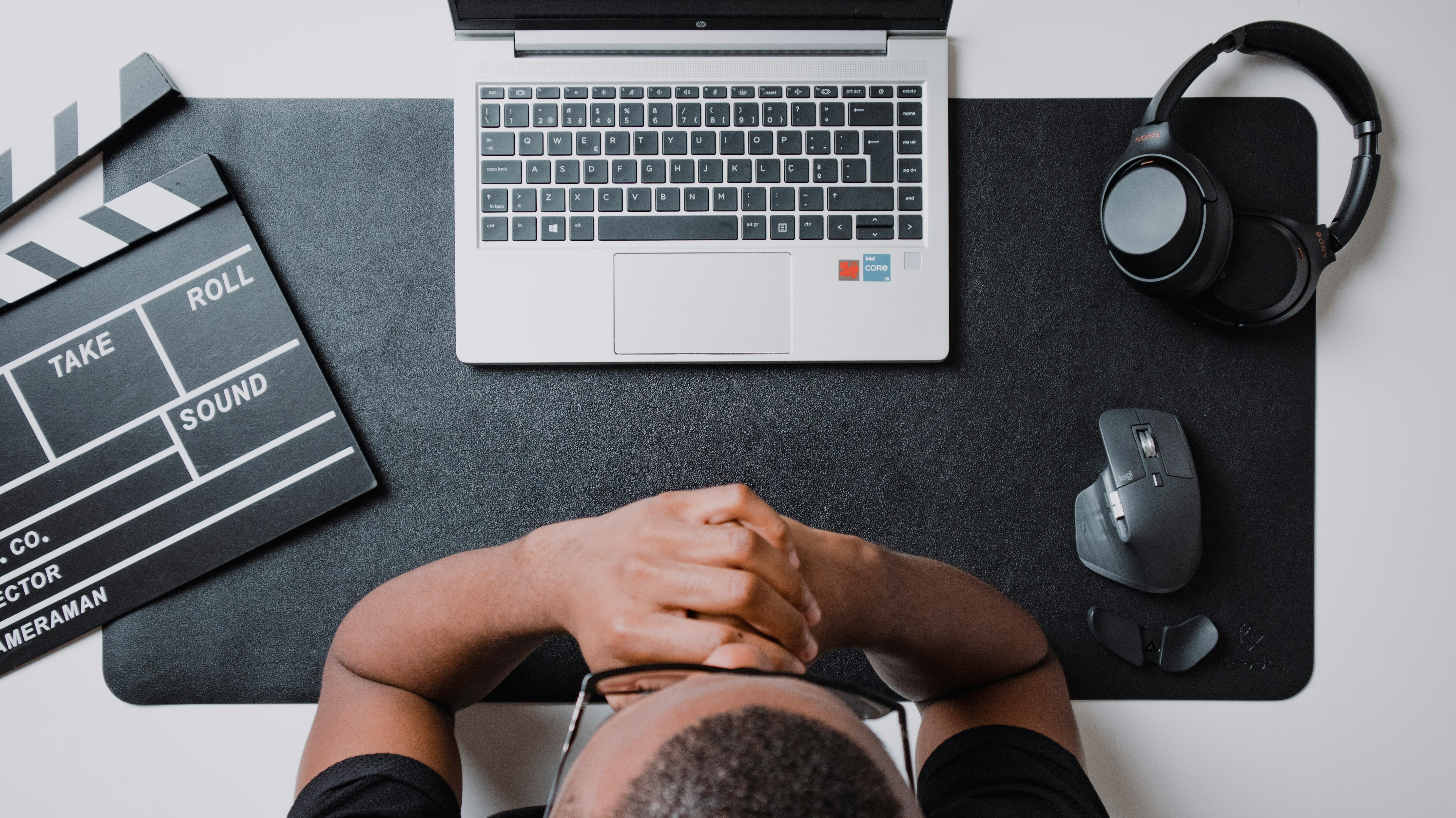 Perspective view of a man editing content on a laptop