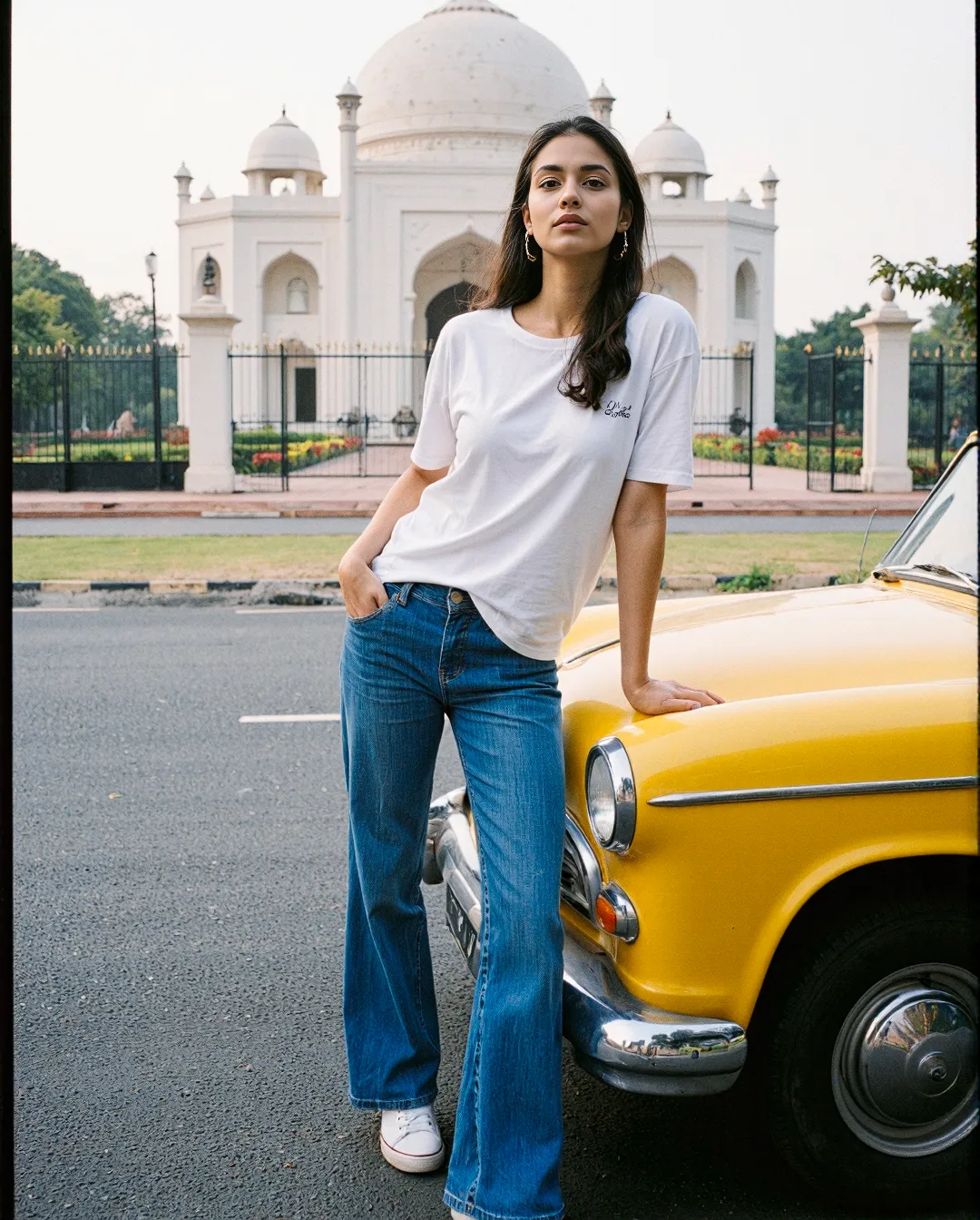 Street style fashion scene featuring blue jeans and white tee against vintage yellow car with stunning white domed architecture in background