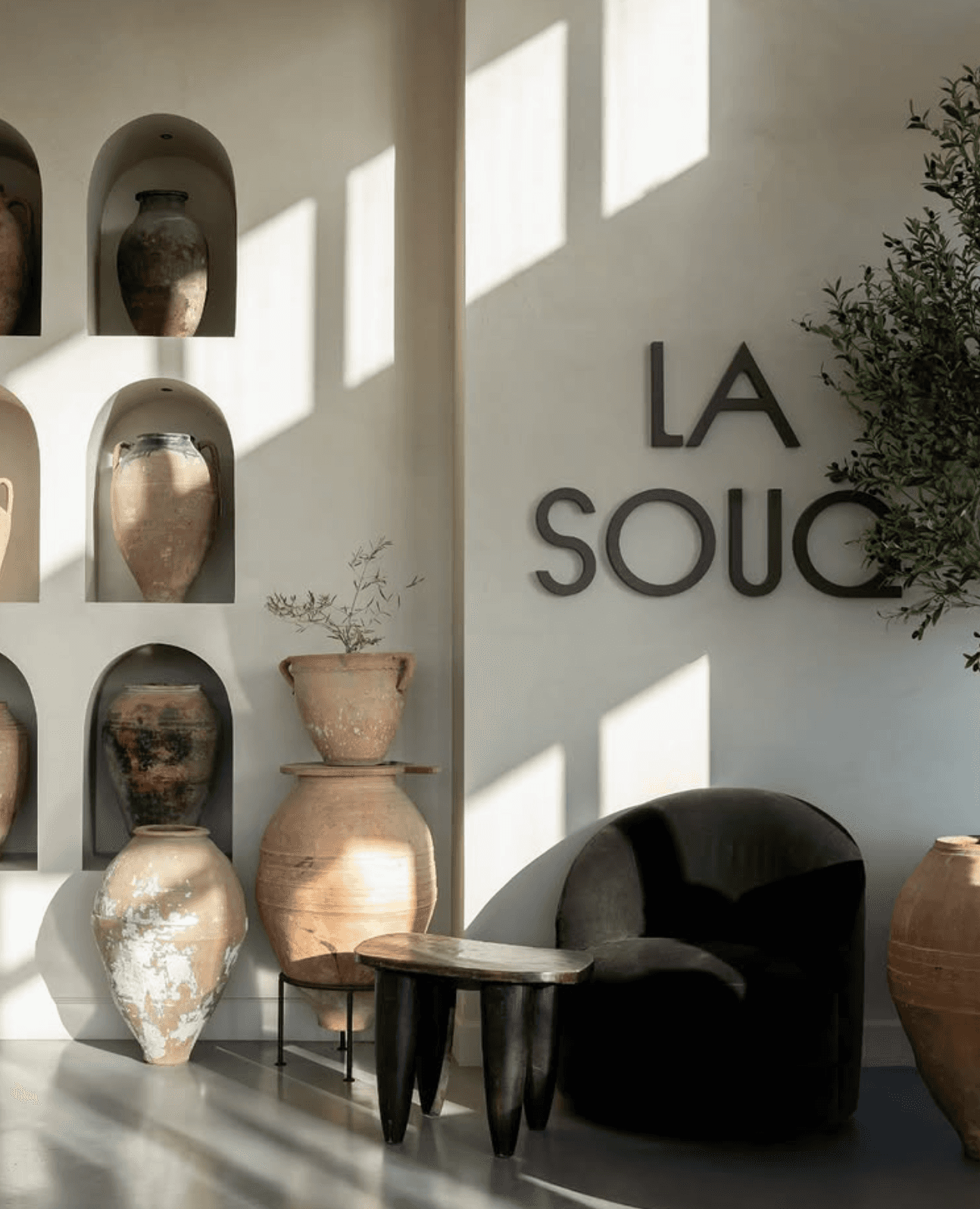 La Souq café interior with dimensional wall logo signage and Mediterranean-inspired seating area.