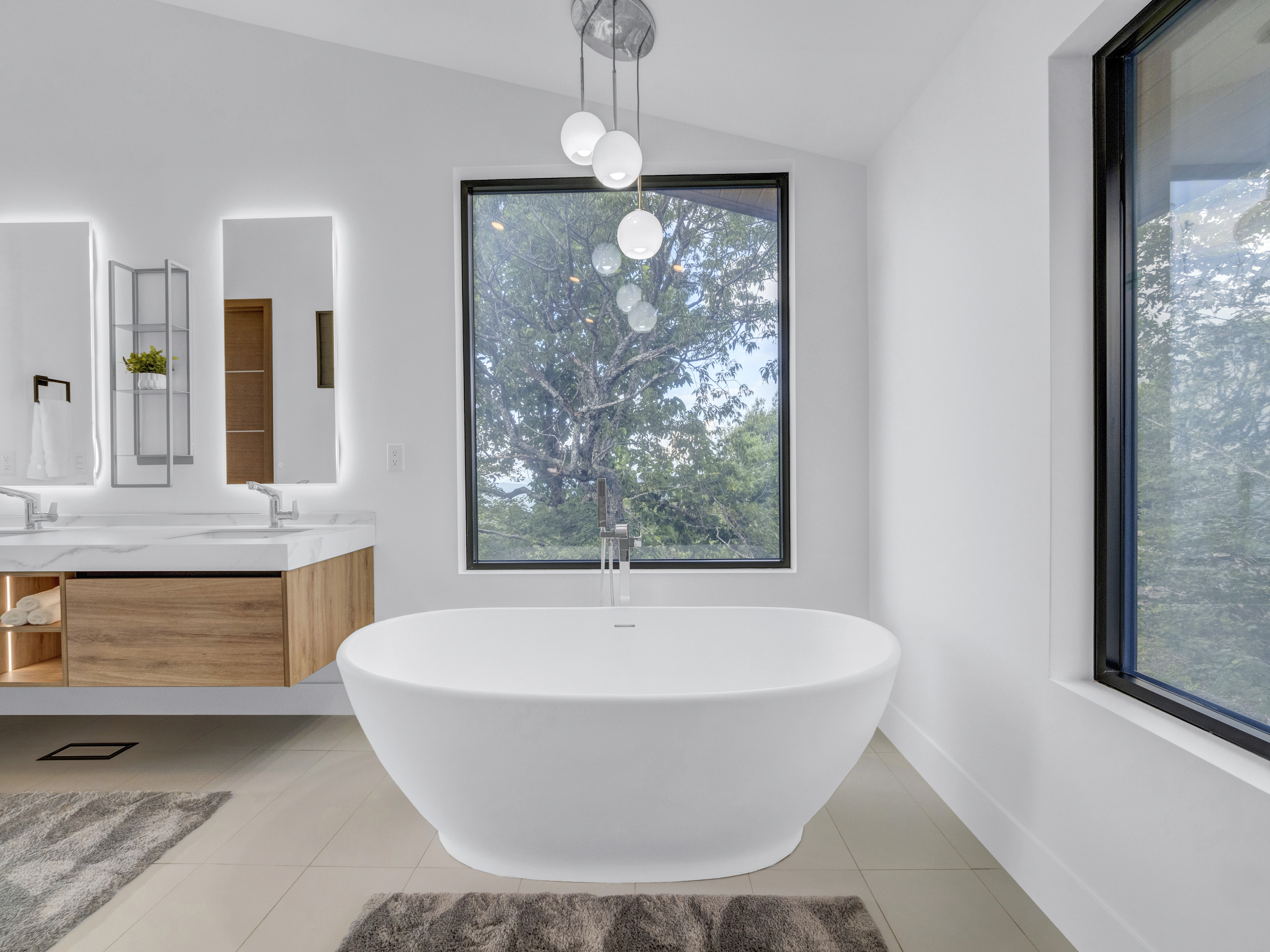 Symmetrical shot of the freestanding tub and window, highlighting the serene and bright atmosphere of the spa