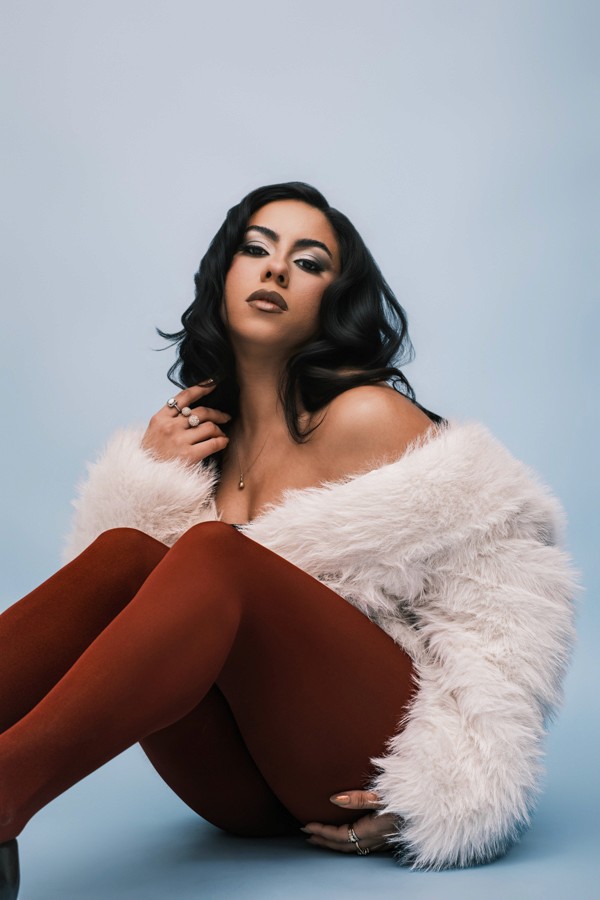 Fashion portrait in a white faux-fur coat and rust tights