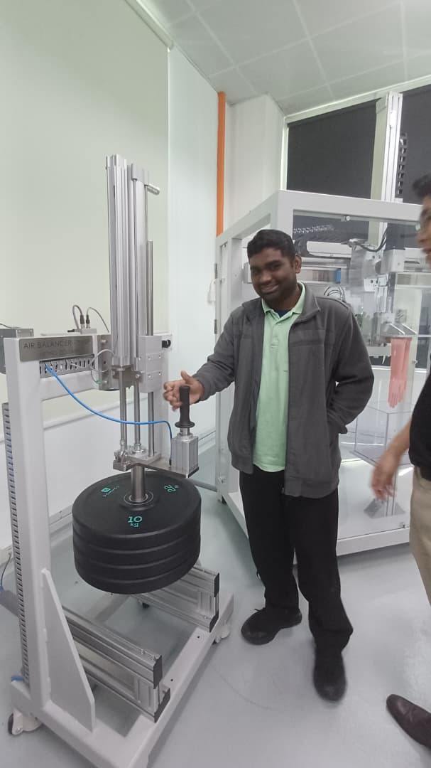 Engineer testing an air balancer system and pneumatic controls during the Festo technical training.