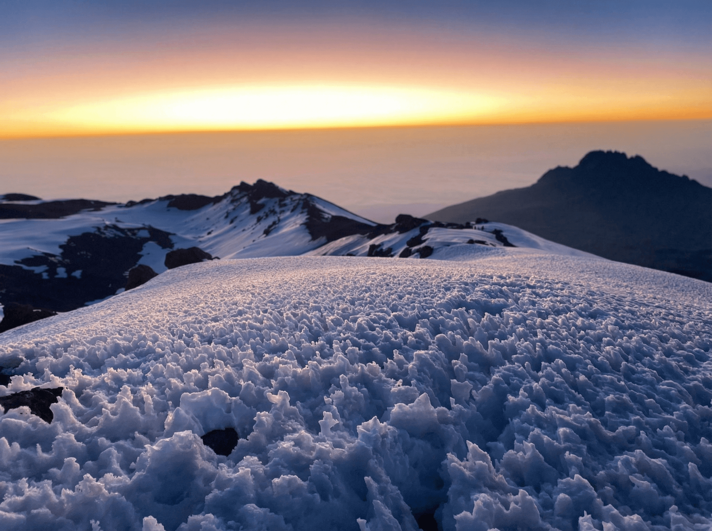 Majestic sandstone formations in AlUla glowing under the afternoon sun, showcasing the desert’s timeless beauty.