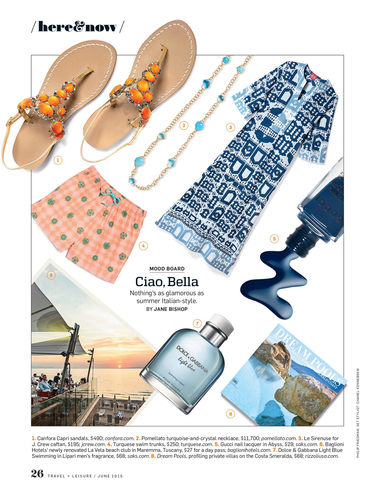 A layout featuring sandals, necklance, swim trunks, cartan, navy nail polish, a fragrance, a book of private villas on the Costa Smerala, and Baglioni Hotel's La Vela beach club overlooking the beach.