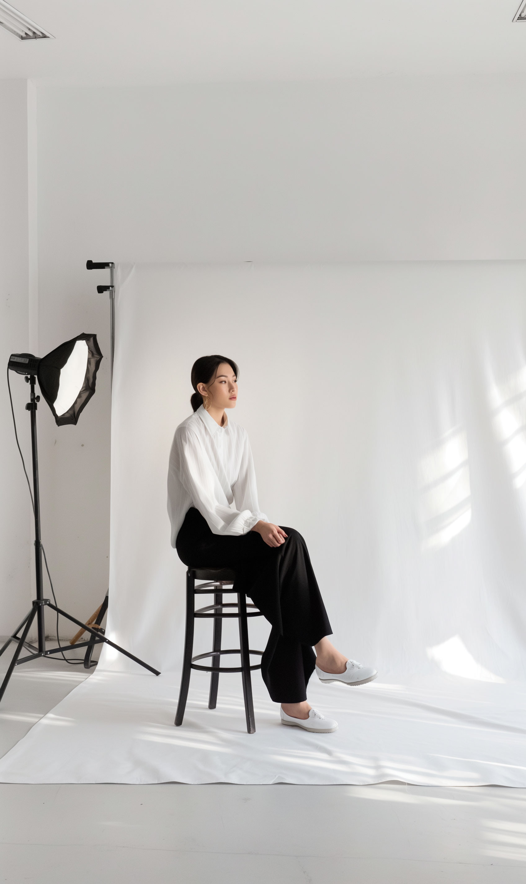 Photoshoot of a young woman sitting on a chair