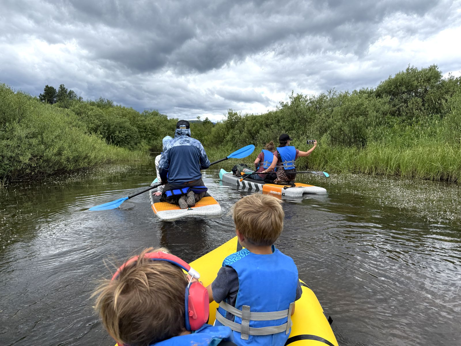 Paddleboarding through the marshy channel on the Clearwater Canoe Trail