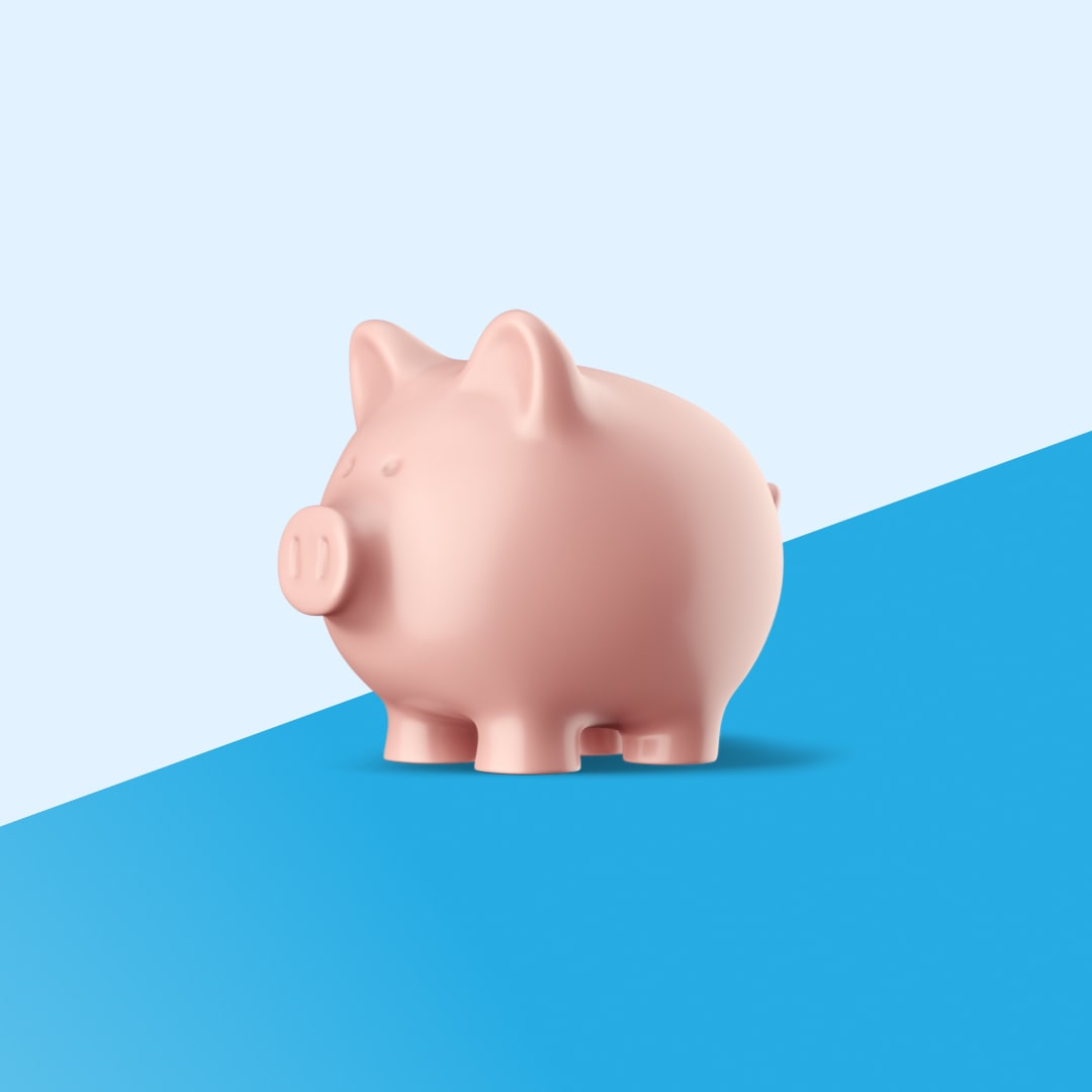 A ceramic piggy bank photographed against a split background of light blue and NCBA sky blue, used as a visual metaphor for savings.