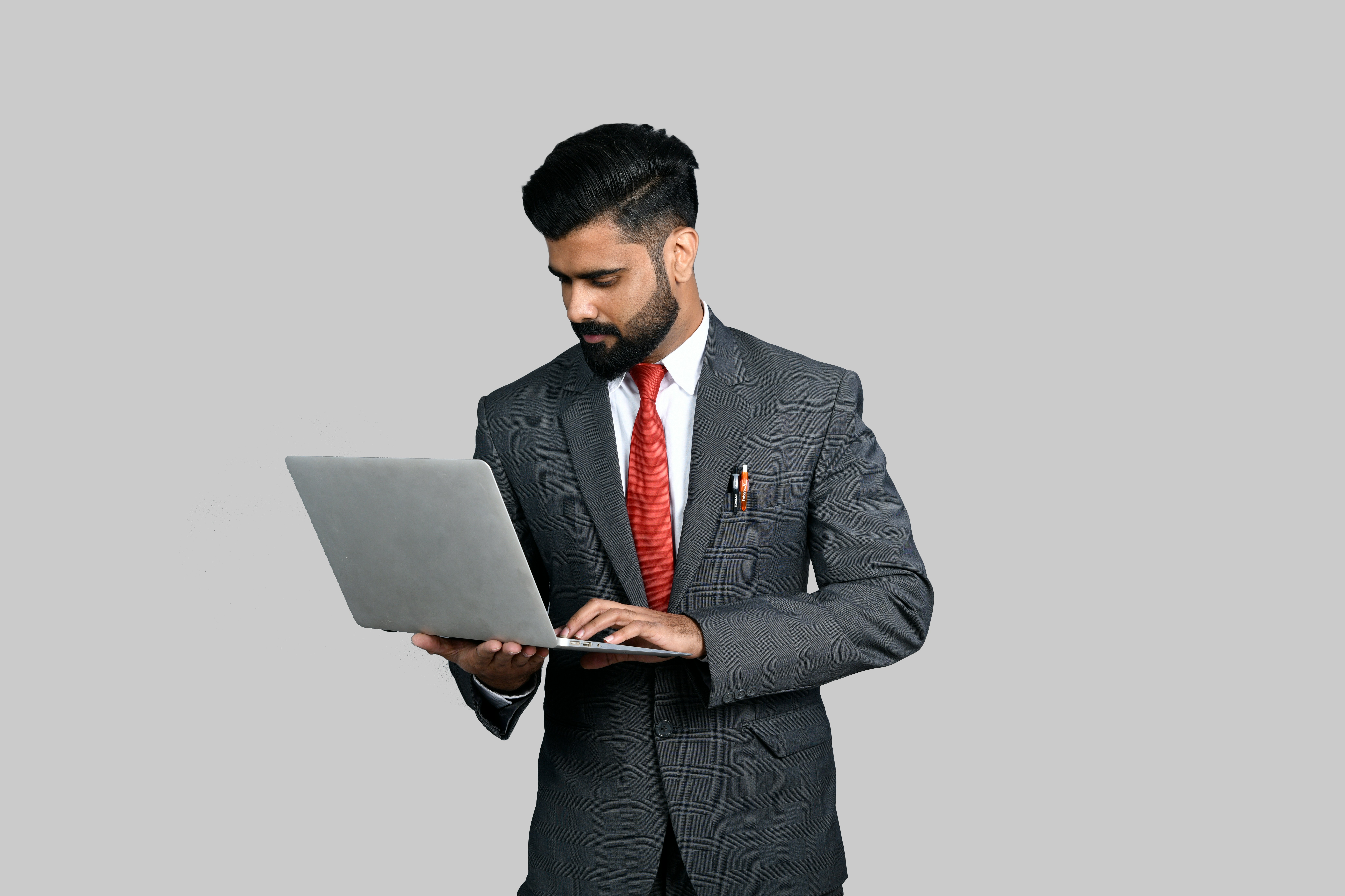 a man in a suit holding a tablet