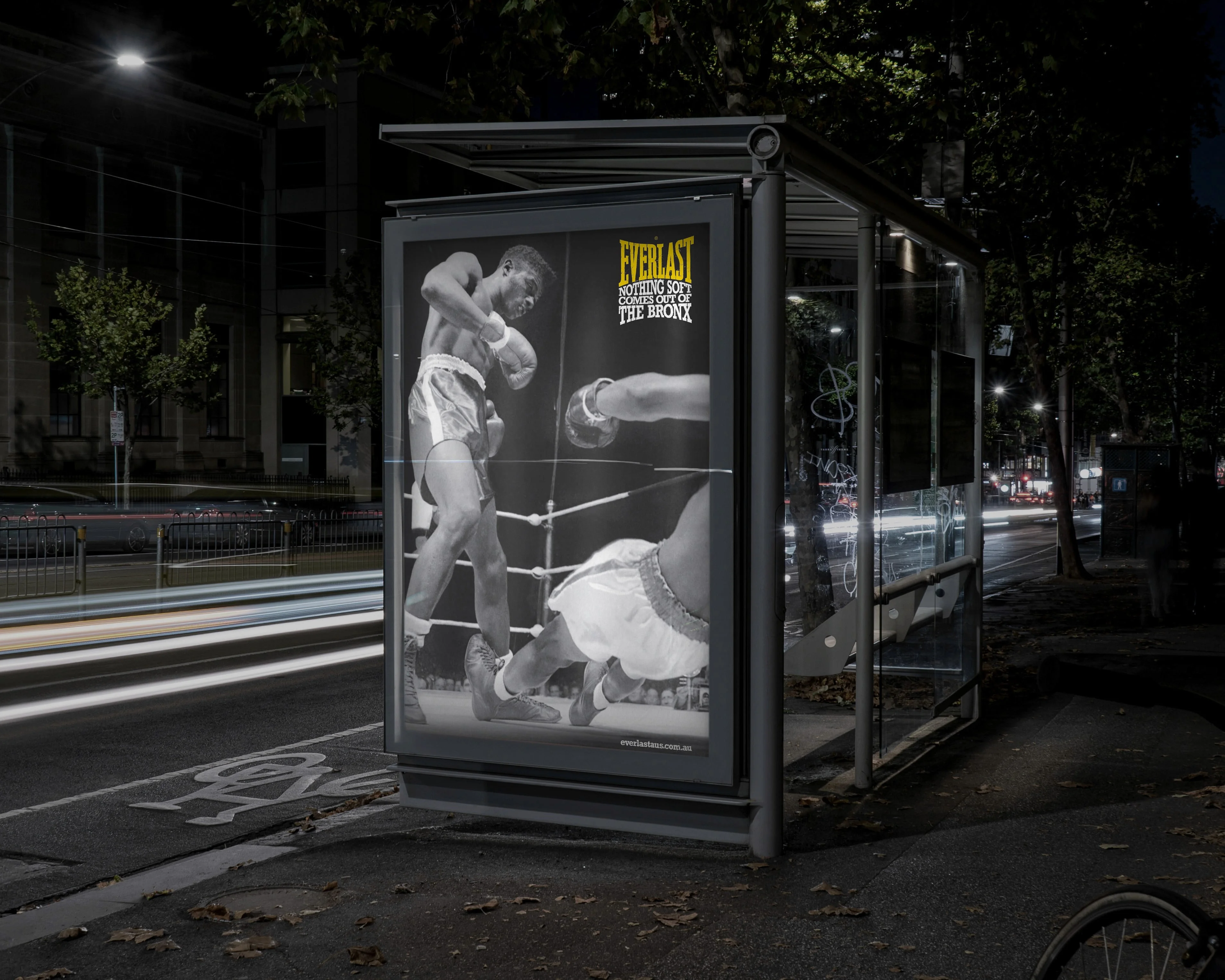Everlast bus shelter poster at night: a boxer standing over a fallen opponent, 'Nothing soft comes out of The Bronx'