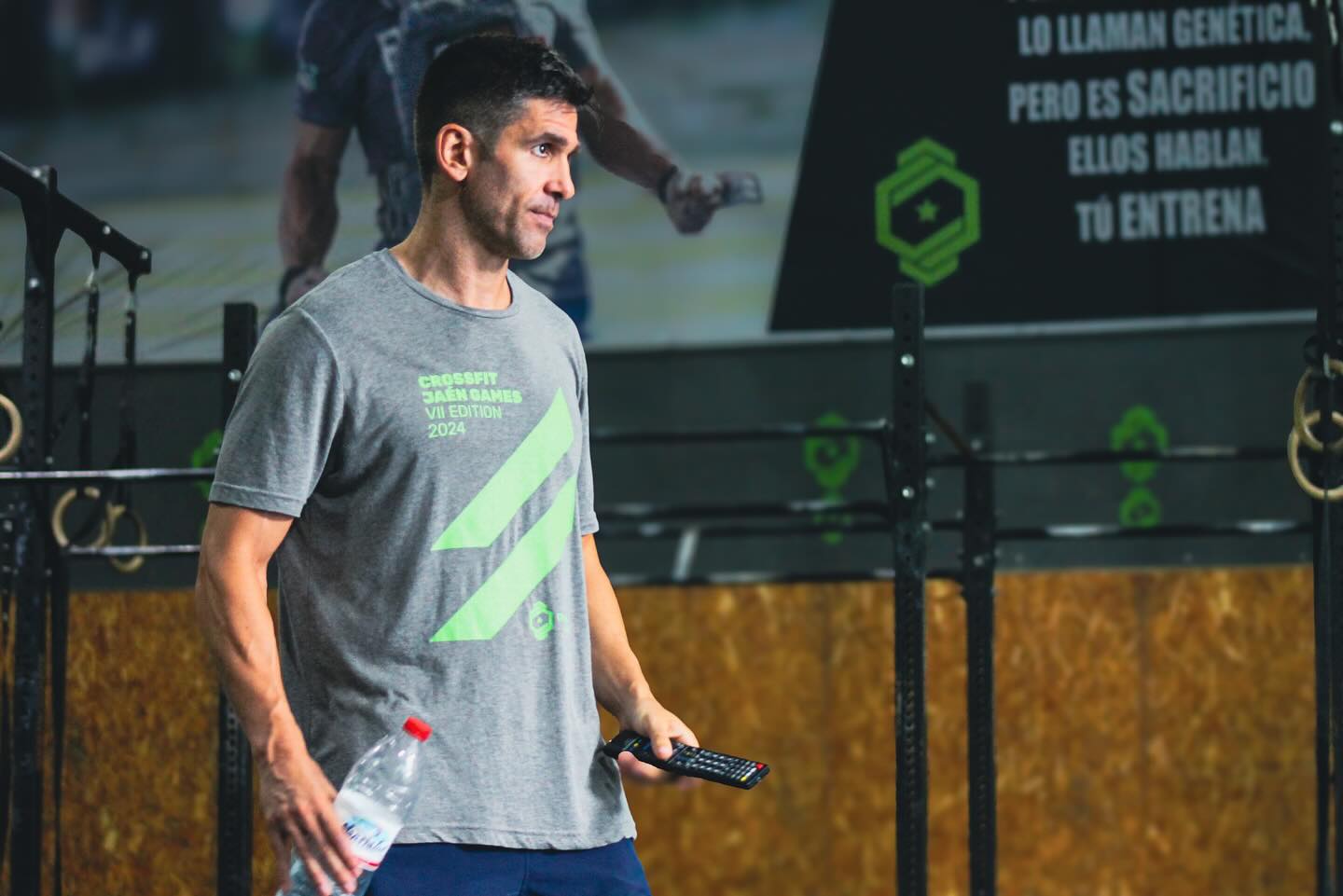 man in black t-shirt and black shorts running on road during daytime