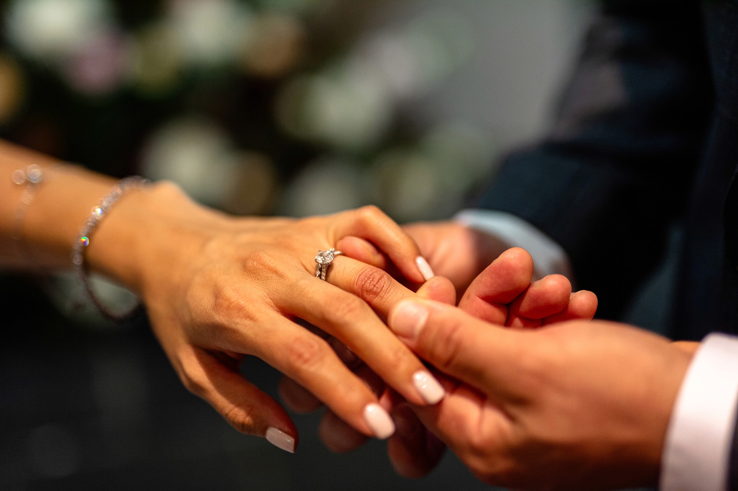 Close-up of wedding ring exchange during ceremony