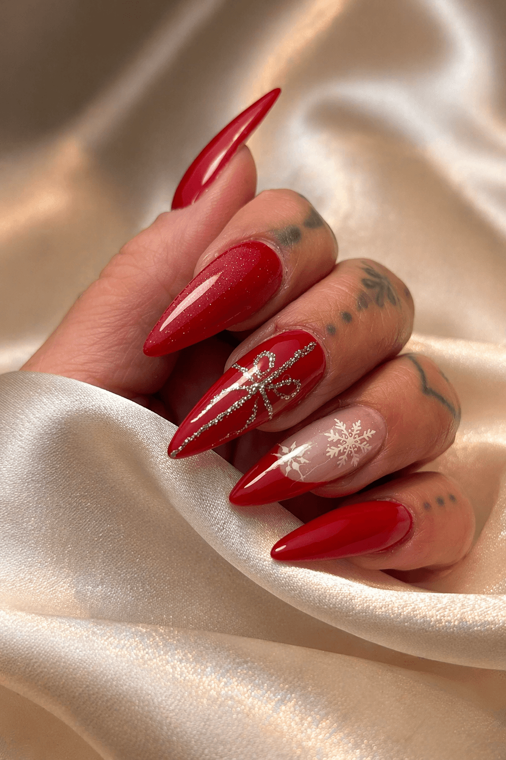 A festive platter of roasted vegetables, including sliced, seared pears or apples and charred tomatoes, garnished with walnuts and rosemary sprigs, set next to a pumpkin, a glass of red wine, and lit candles for a holiday or autumn meal.