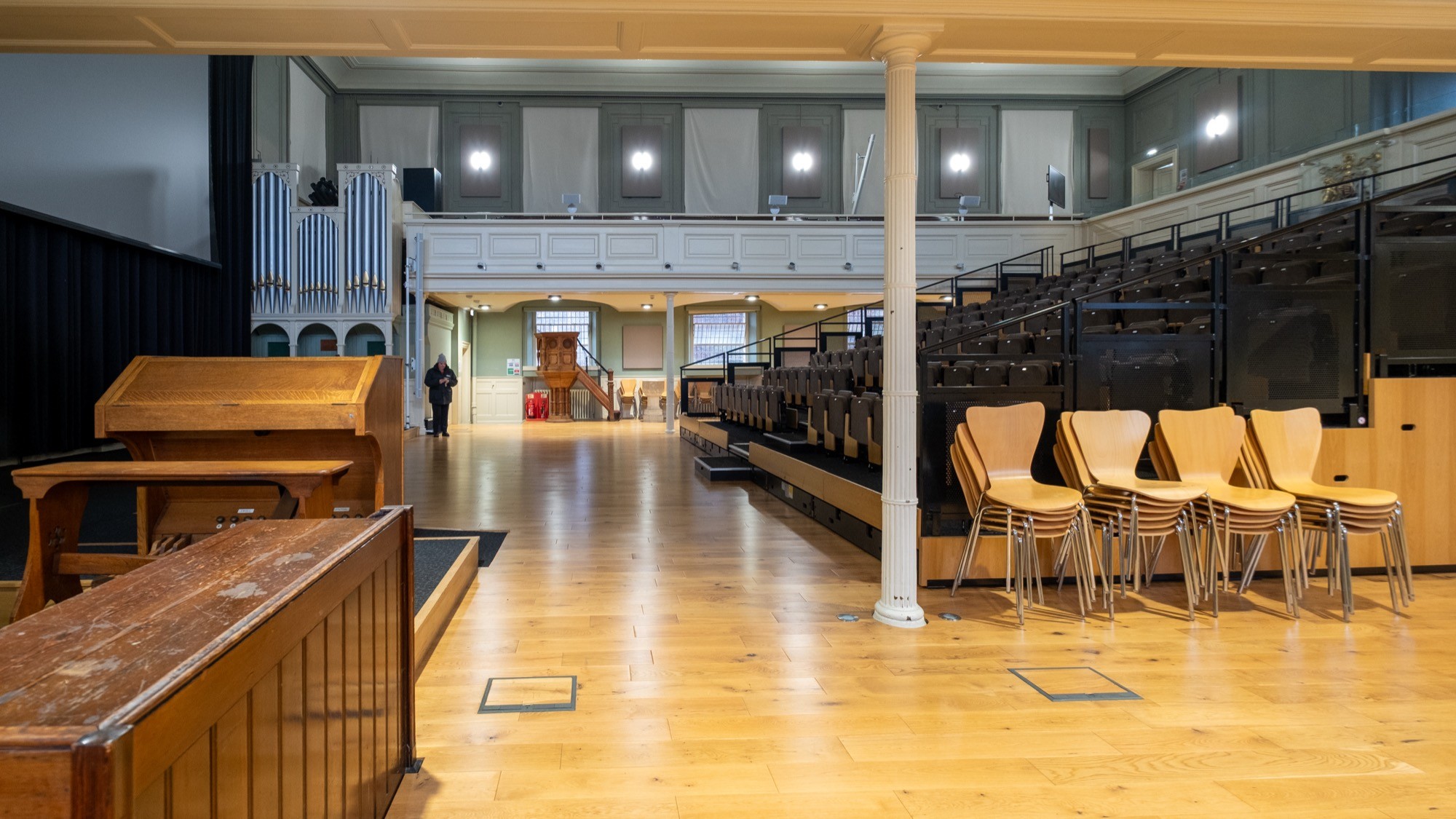 Two classic volkswagen beetles, one green, one cream.