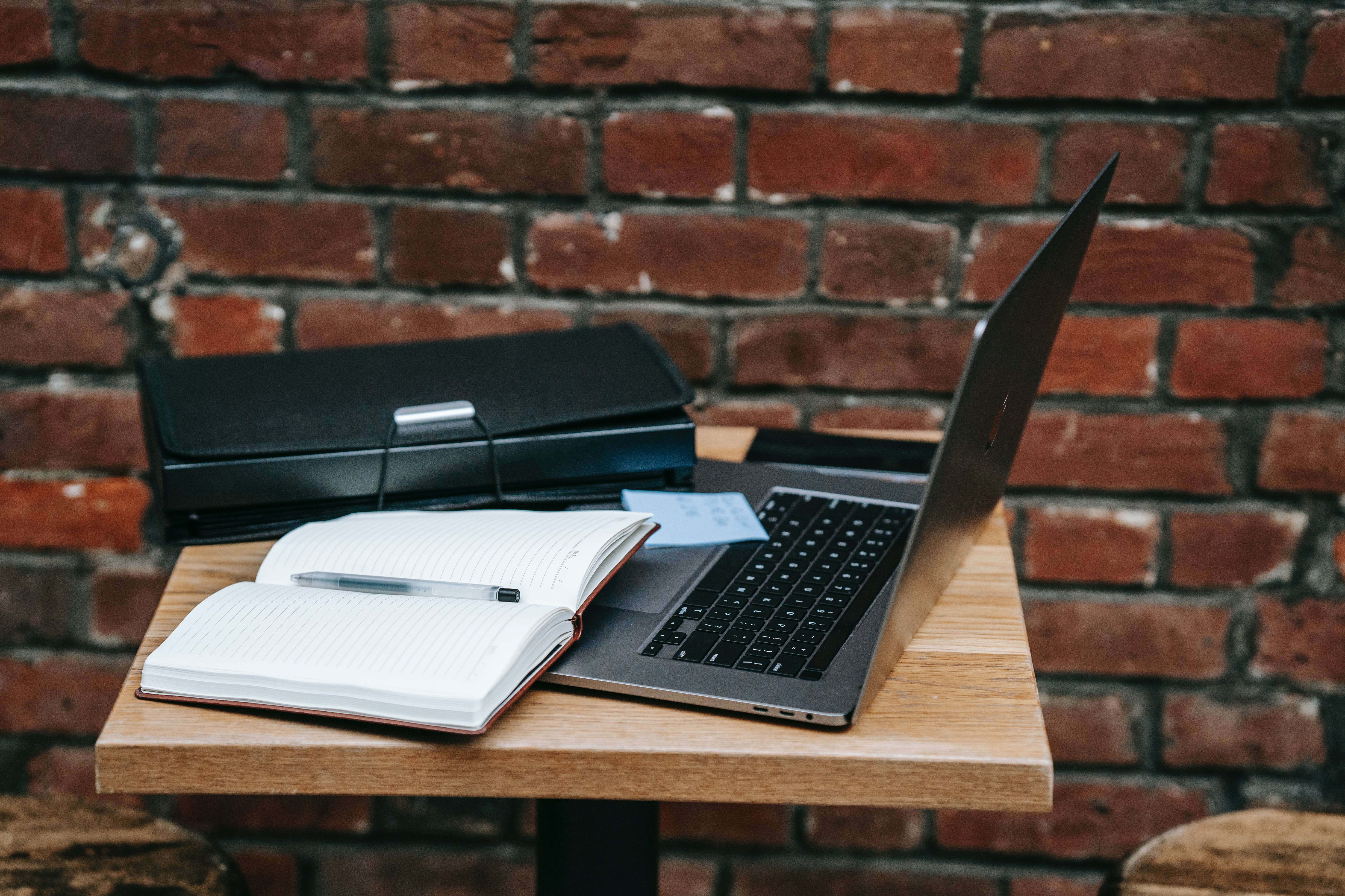 Gray laptop on wooden table for cold emailing