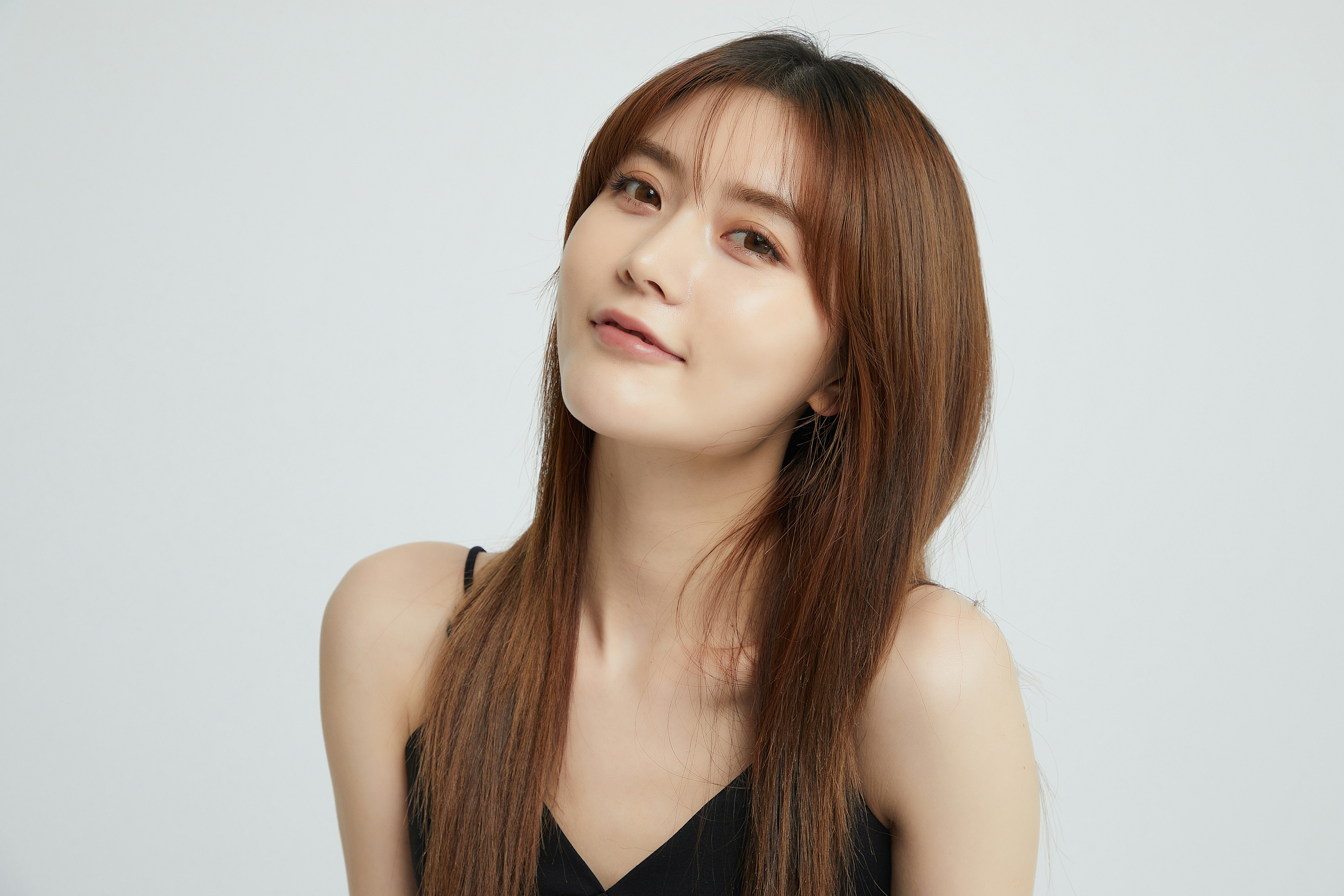 a woman with long hair and a black top