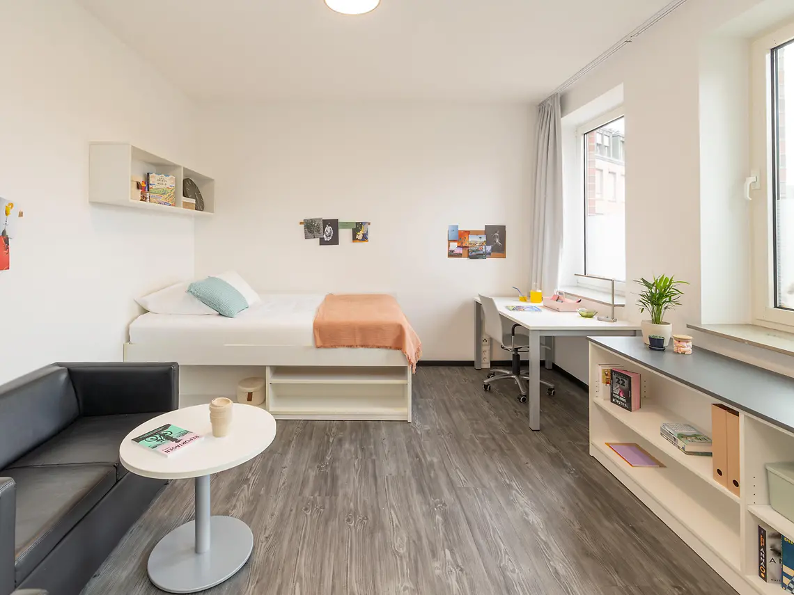 Private student studio in Münster with bed, desk, sofa and built-in storage