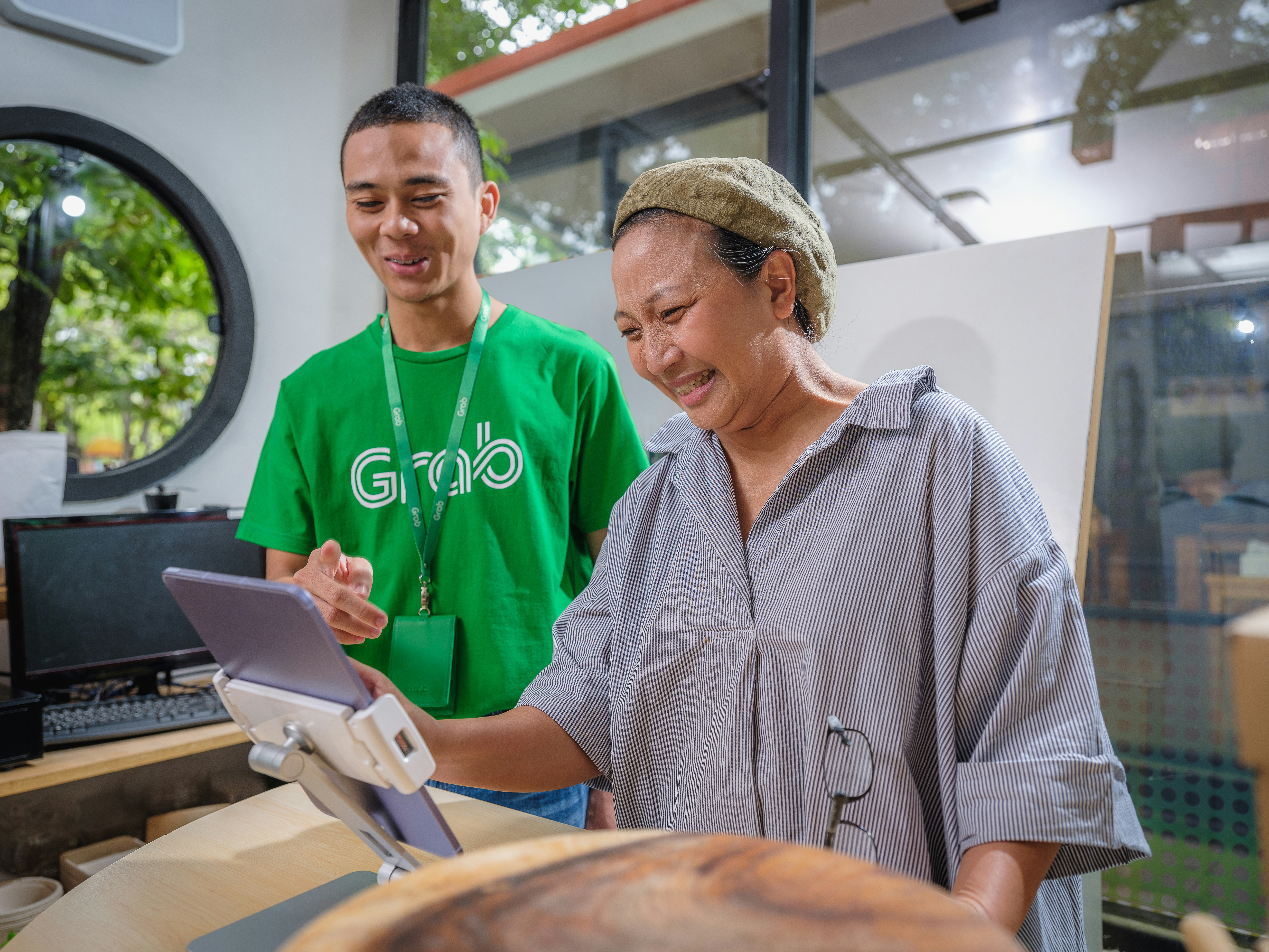 a man and a woman looking at a tablet
