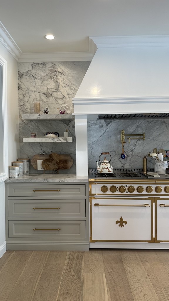 inset custom cabinetry grey shaker with custom hood floating marble shelves