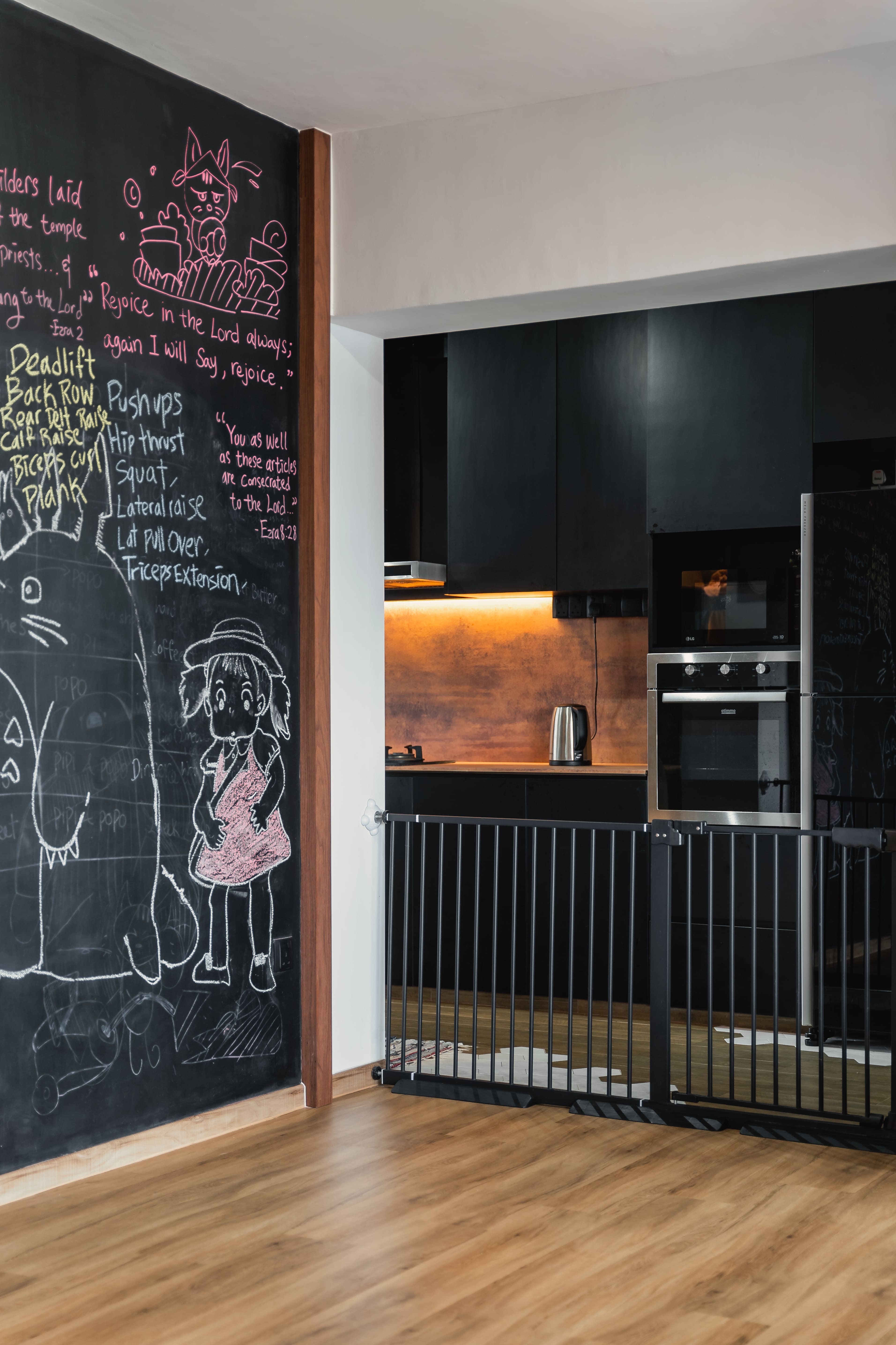 A family-friendly kitchen space framed by a chalkboard wall, blending practicality with playful creativity.