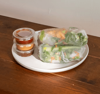 trays of california rolls and crunchy rolls