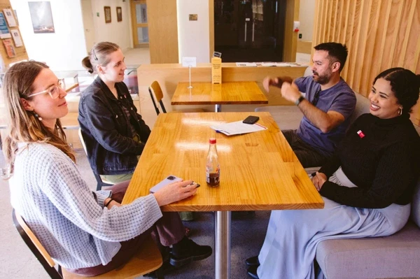 Small group seated around a table in the Cloister Café