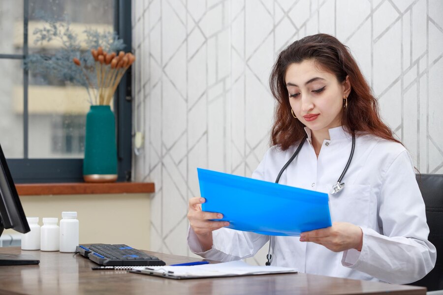 A doctor checking patients records and reports.