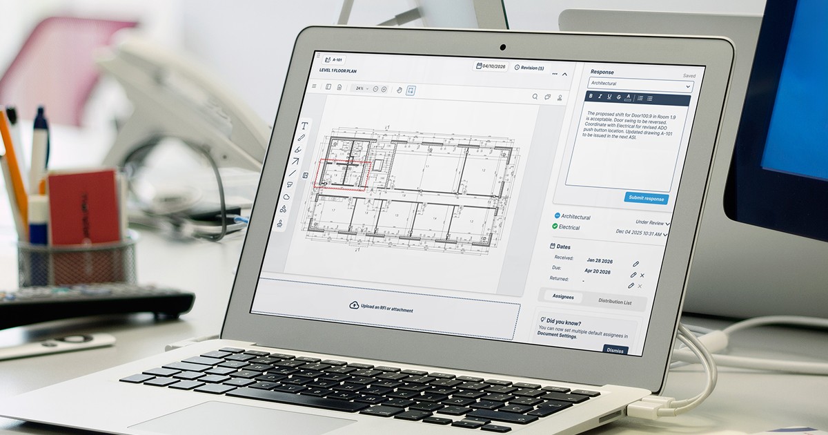Workspace with laptop showing architectural drawing review and response tools in construction software