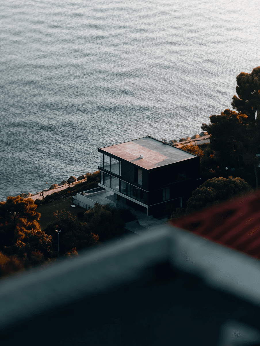 An arial view of a flat topped house near the lake shore