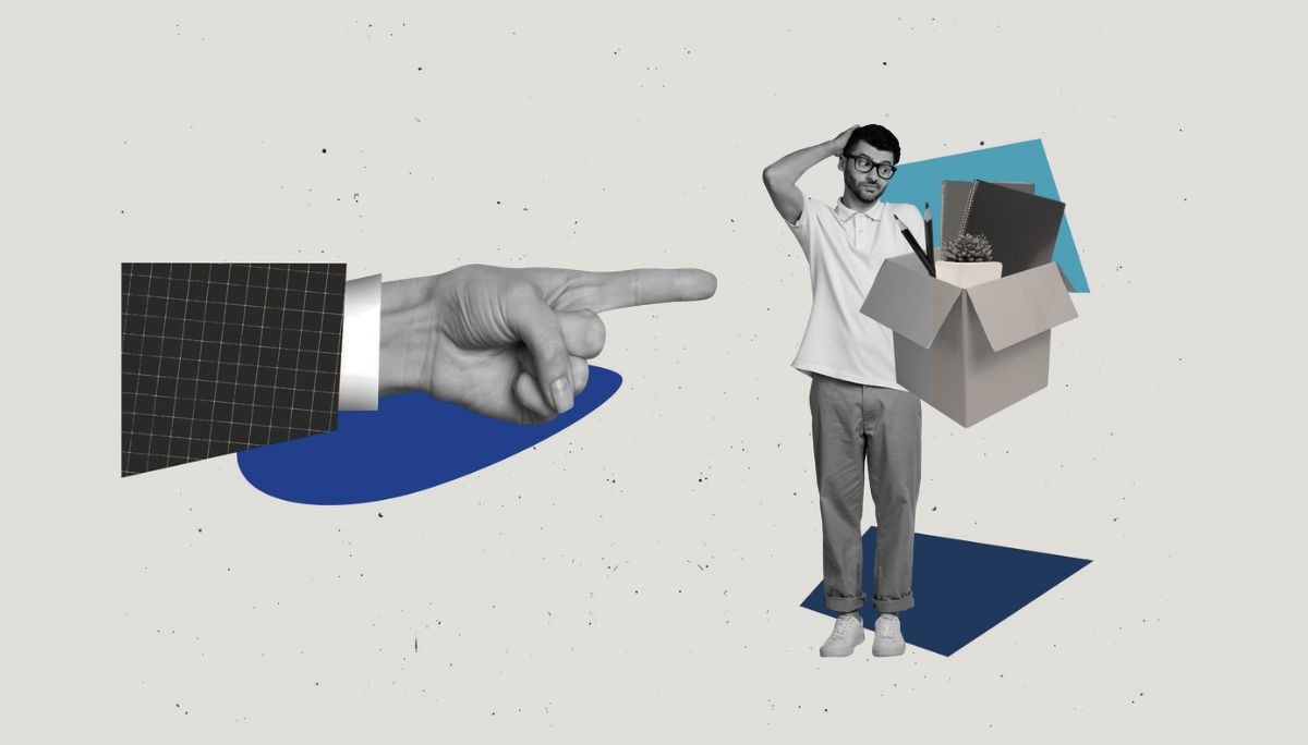 Employee carrying belongings in cardboard box, representing impact of Meta layoffs.