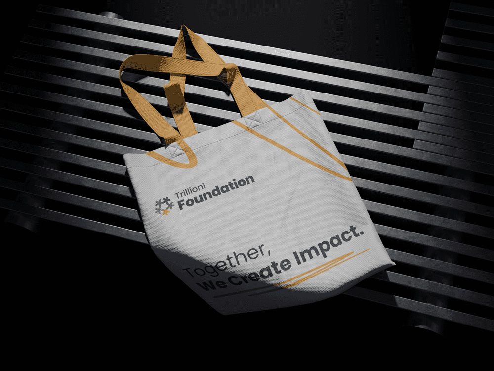 Trillioni Foundation tote bag with tagline ‘Together, We Create Impact,’ showcasing non-profit branding design for humanitarian and community initiatives.