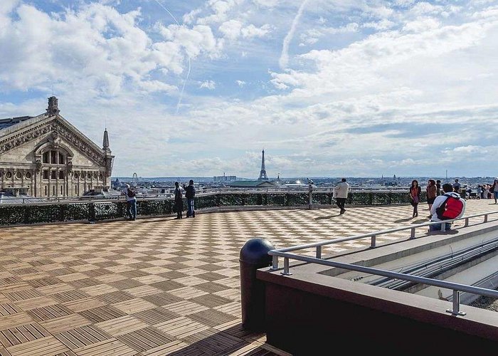 red train travelling near body of water