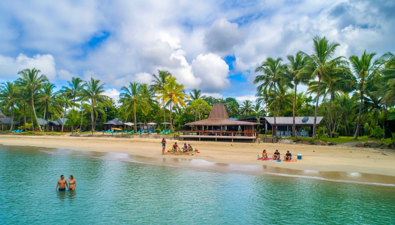 A beautiful beachfront at Uprising Beach Resort with turquoise water and guests in water & on beach