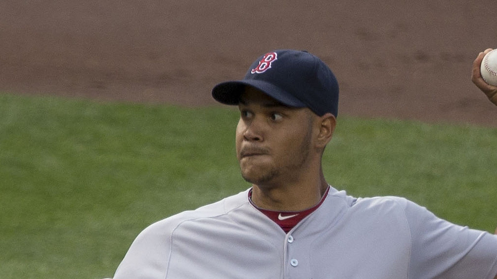 Eduardo Rodriguez pitching in a Red Sox road jersey, face clearly visible under a cap