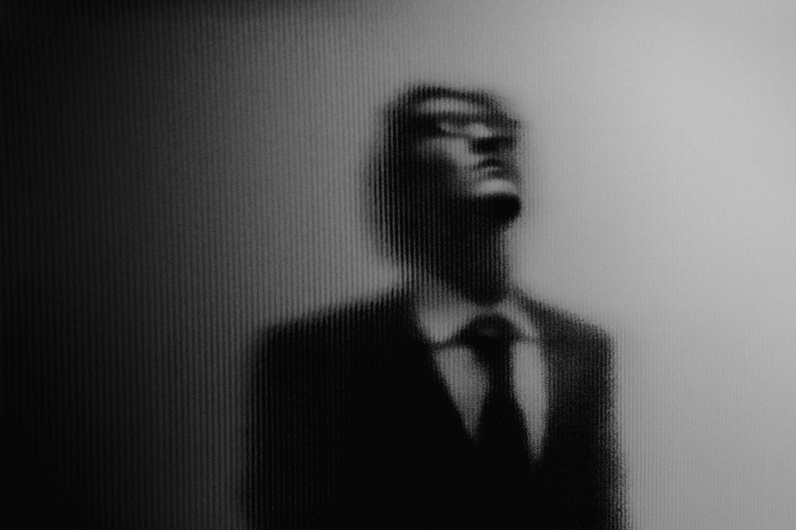 character in outline production posing behind glass