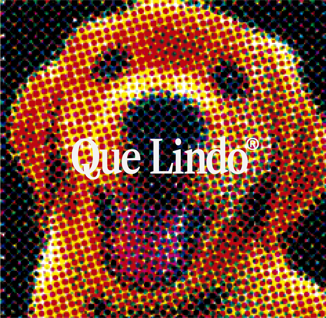 A man with curly hair smiling in a field of yellow flowers at sunset.