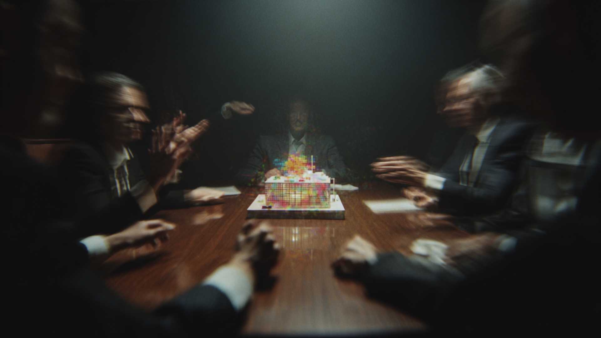 A cinematic shot of a white architectural model of a stage being projection mapped live in a boardroom, representing the future of event prototyping and sales.