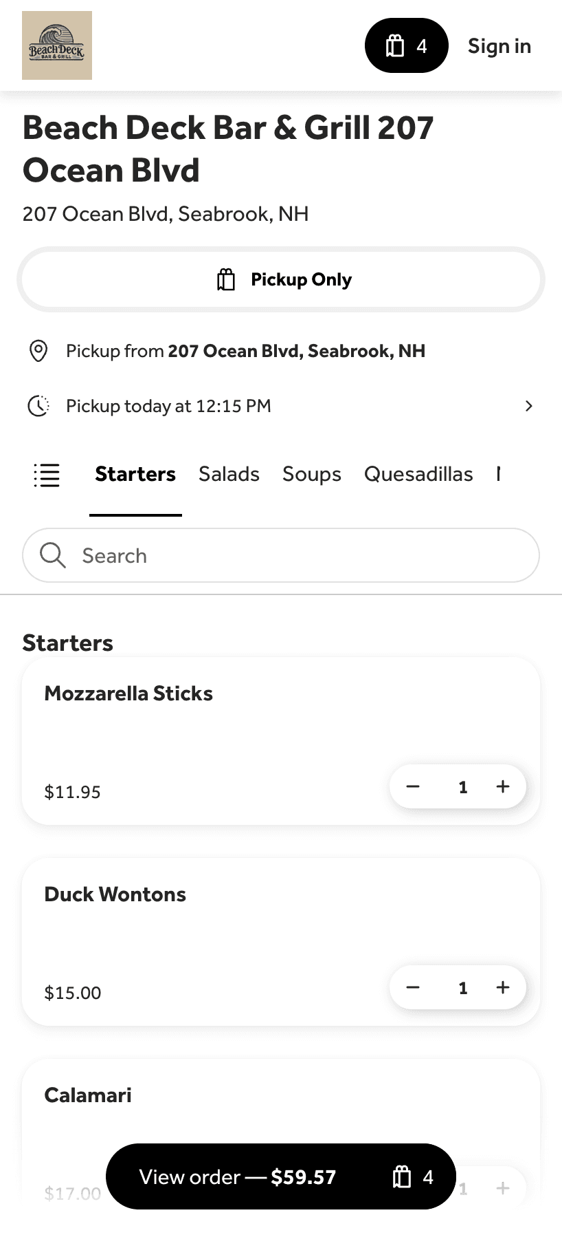 An elephant with large tusks in a lush green landscape.