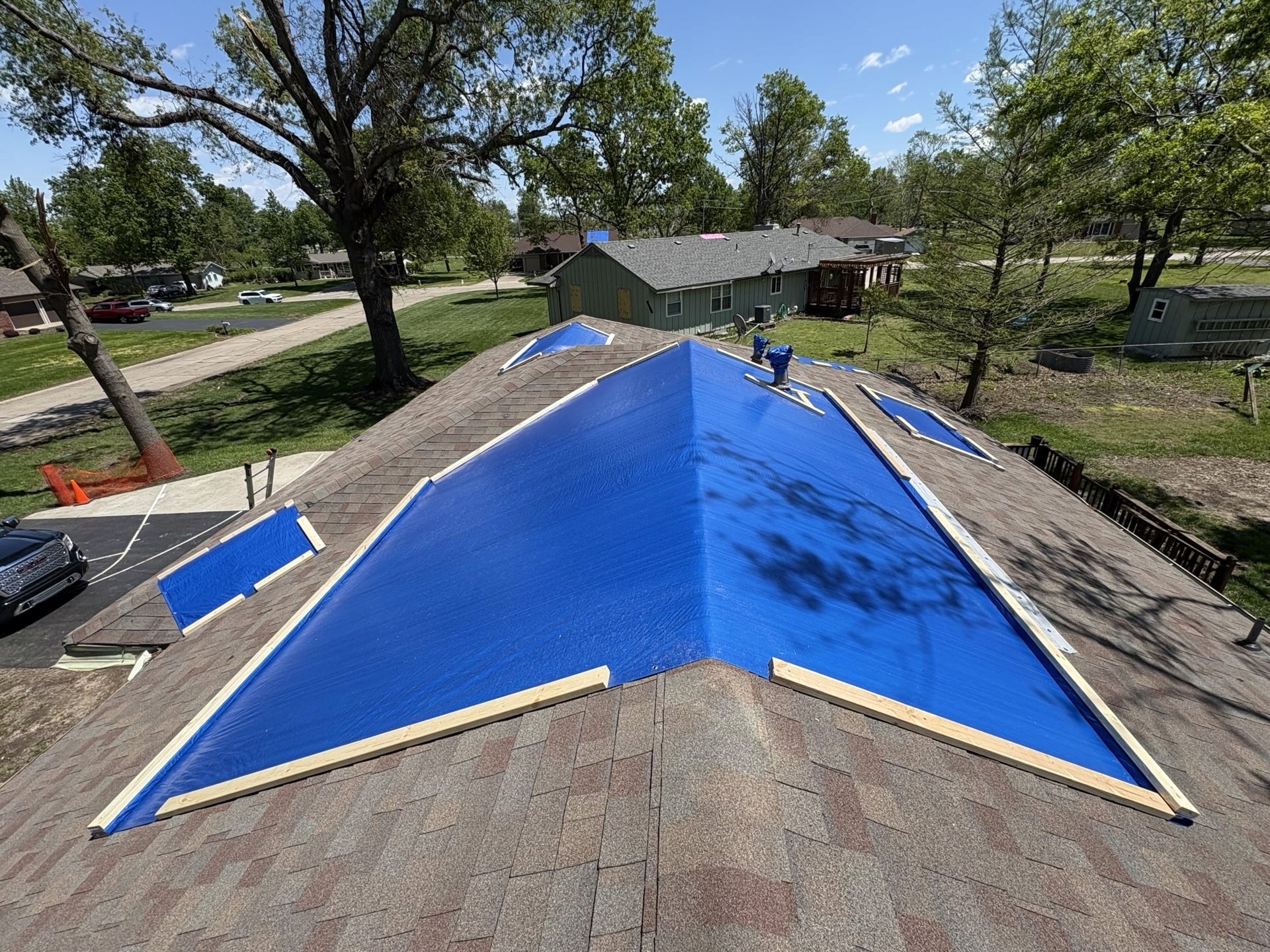 Tornado in Ottawa KS blew tree branches through customers roof, we installed emergency tarps with bolted down lumber to prevent blow off.