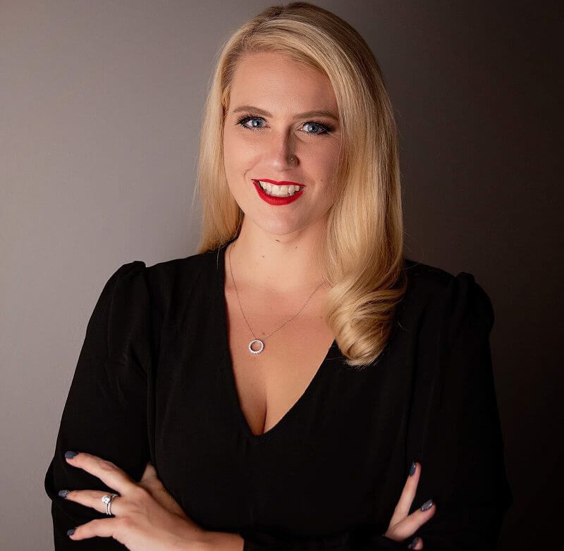 A close-up of a person receiving an ear cleaning, with hands gently handling their ear.