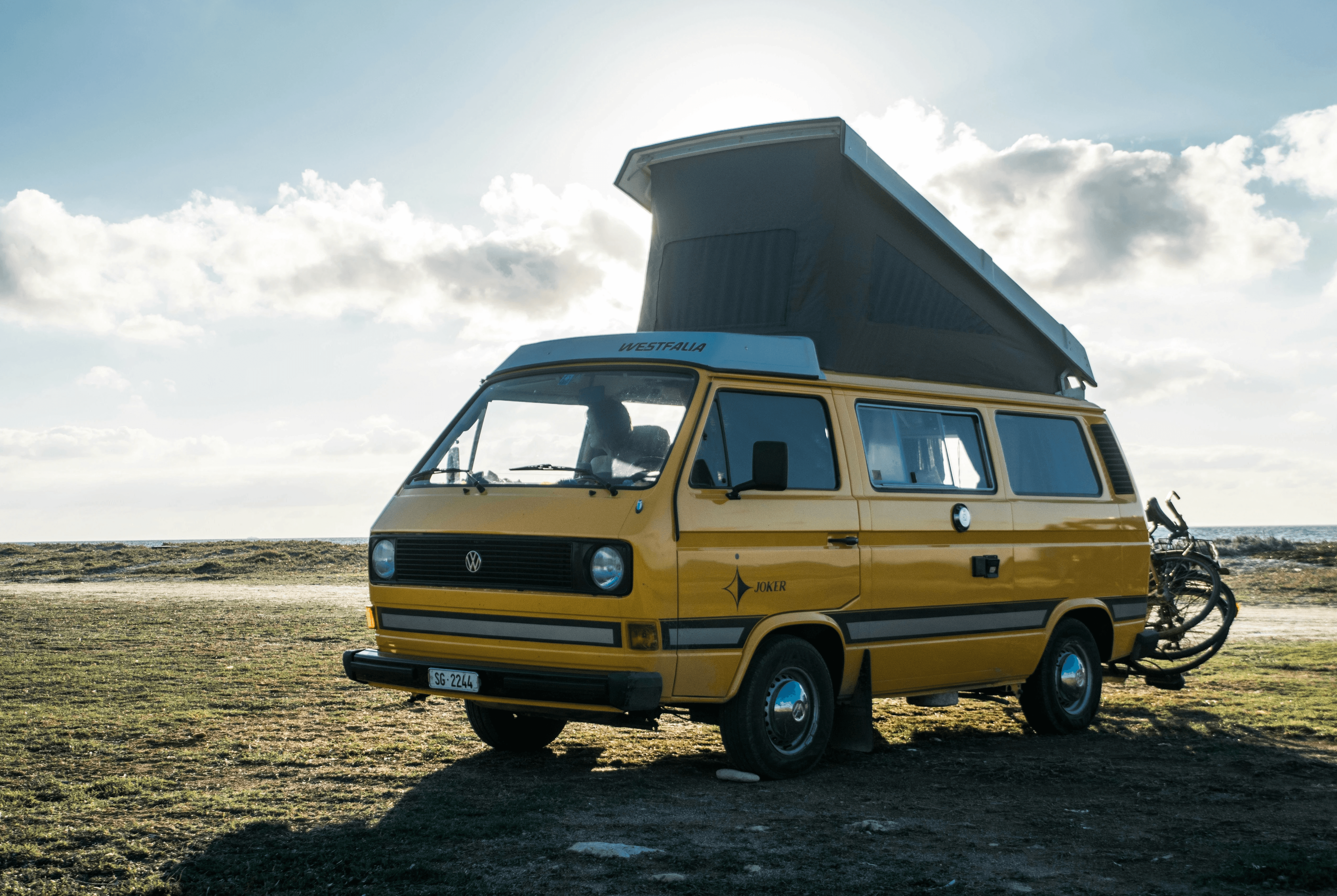 yellow Renault van parked on green grass at daytime