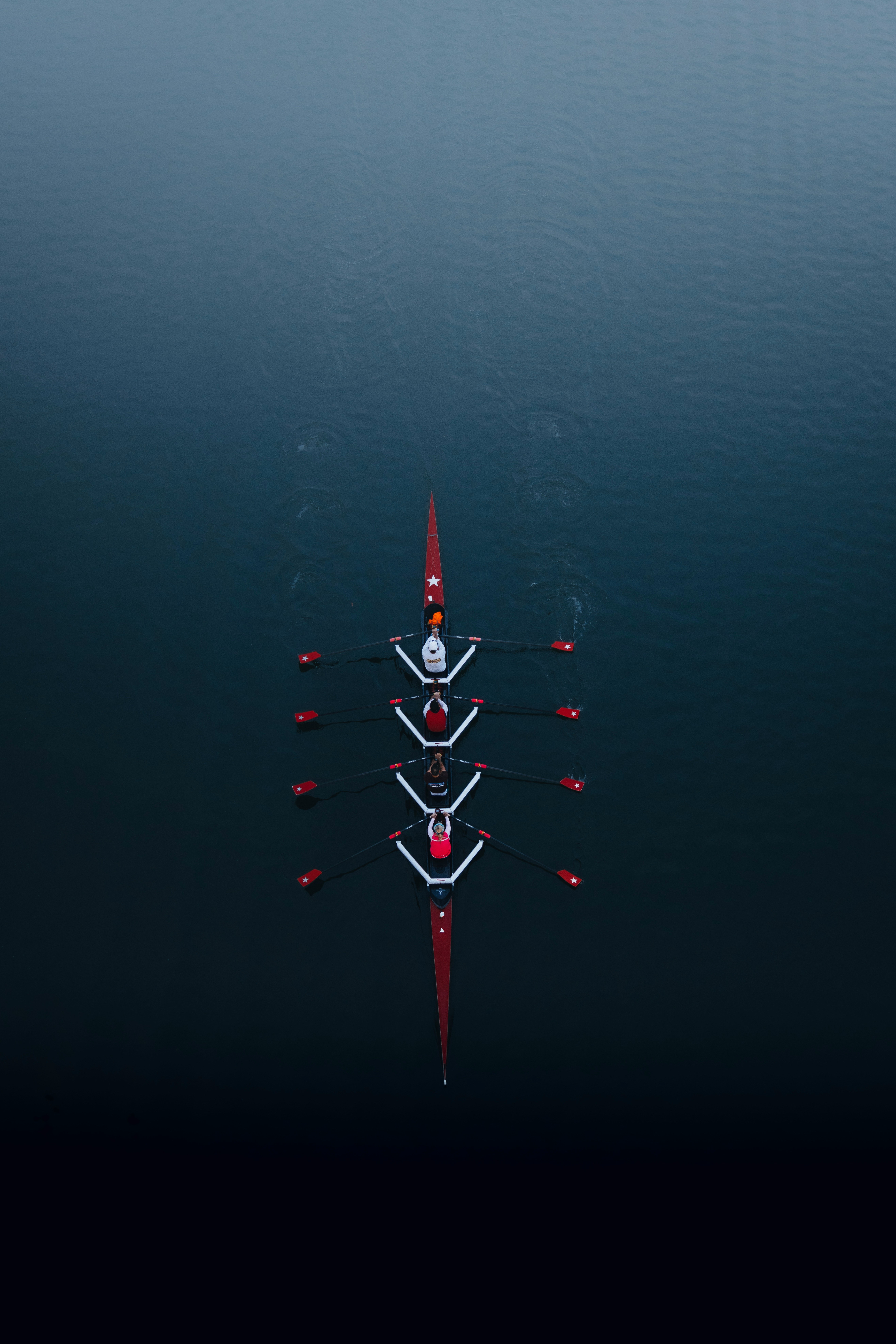 a row of boats floating on top of a body of water