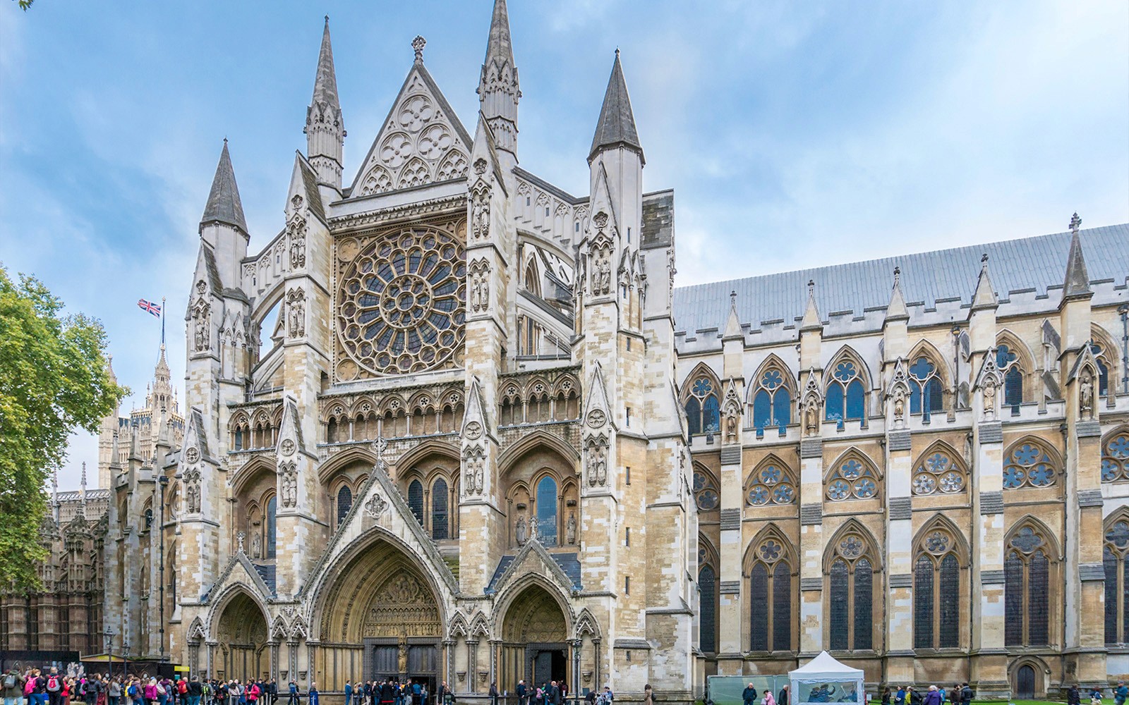 Westminster Abbey exterior with tourists, London.